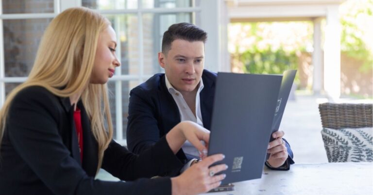 Two professionals collaborating on a laptop.