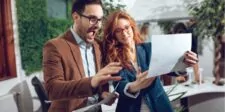 What Is a Full-Stack Marketer? Career Guide & Growth Tips Two colleagues excitedly reviewing documents together in an office setting.