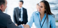Woman in a blue shirt shaking hands with a man. Text: "Elevate Your Networking Game! Build Connections That Last."