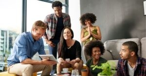 Team collaborating with a tablet in a casual setting.