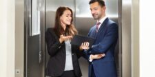 Components of an Elevator Pitch: How to Stand Out Instantly Two professionals in an elevator discussing on a tablet.
