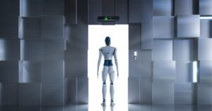 Robot standing at an open elevator, facing forward.