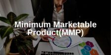 Person reviewing marketing diagram. Text overlay: "Minimum Marketable Product (MMP)."