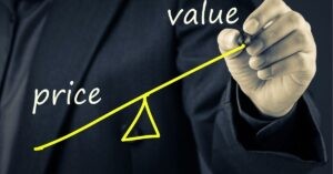 Hand drawing a balance scale with "Price" and "Value" on either side.