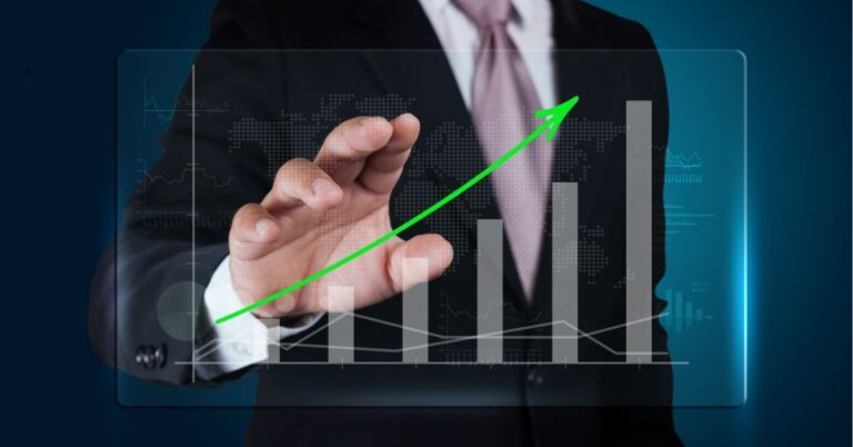 Businessperson touching a digital graph with an upward green arrow, symbolizing growth.