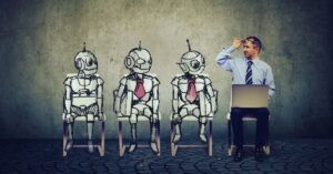 A businessman with a laptop sits beside three hand-drawn robots wearing red ties, symbolizing AI coworkers or virtual employees.