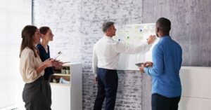 Team collaborating at a whiteboard, planning project tasks.