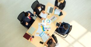 Business team reviewing charts and data at a conference table.