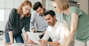 Team reviewing documents together in an office.
