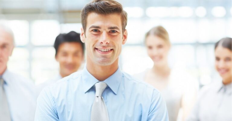 Smiling professional in a group setting, showcasing teamwork.