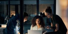 Team collaborating on a project late at night in an office.