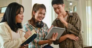 Team collaborating with a tablet and taking notes.