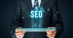 Person holding a tablet with "SEO" and search icon above.
