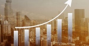 City skyline with a graph overlay showing an upward trend.