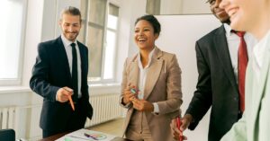 Team of professionals enthusiastically discussing a project in a meeting.