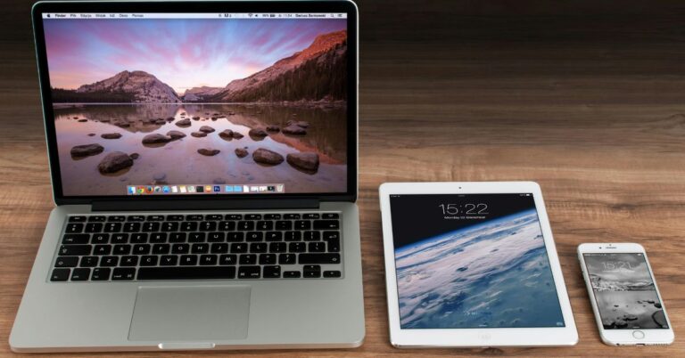 Laptop, tablet, and smartphone on a desk, representing modern devices that support eSIM technology for seamless mobile connectivity.