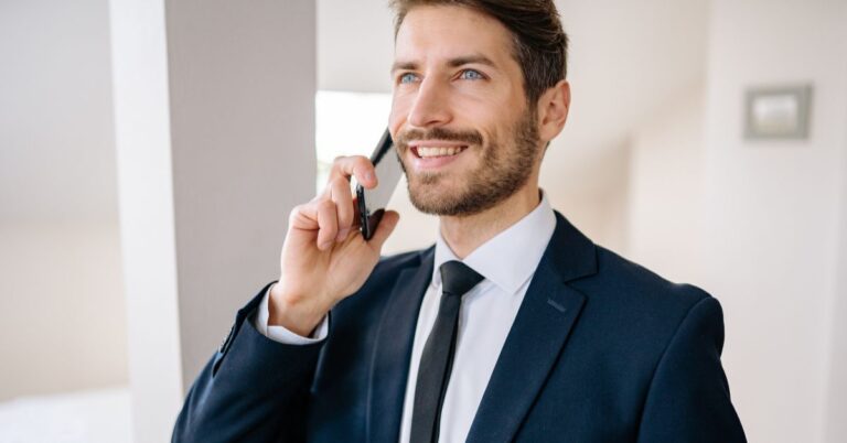 Business professional in a suit talking on the phone, representing enterprise sales and high-value client acquisition.