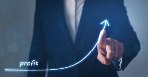 Business professional pointing at a glowing upward arrow labeled "profit."