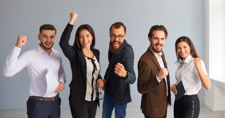 Team celebrating success with fists raised, showing excitement and achievement.