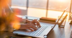 Laptop showing a marketing one-pager: A digital one-pager on a laptop screen with colorful graphs and bullet points.