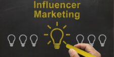 Chalkboard with "Influencer Marketing" written and a highlighted light bulb illustration.