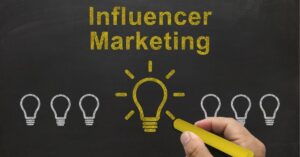 Chalkboard with "Influencer Marketing" written and a highlighted light bulb illustration.