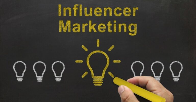 Chalkboard with "Influencer Marketing" written and a highlighted light bulb illustration.