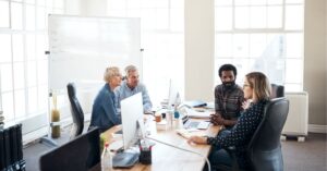 Team of professionals in a conference room having a discussion.