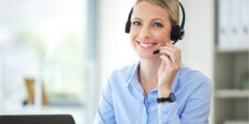 Smiling customer support representative wearing a headset, ready to assist.