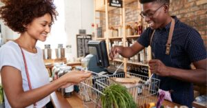 Person brainstorming with sticky notes and a laptop, symbolizing creativity and planning