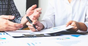 Team collaborating with laptops in a modern office.