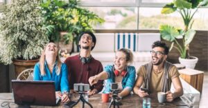 Group of friends laughing and recording a video together.