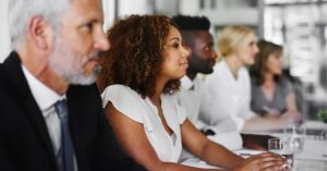 Diverse professionals focused during a presentation
