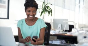 Colleagues discussing ideas around a whiteboard