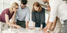 Native Content: Strategies That Drive Attention Without Breaking Trust Team Collaboration: Four professionals in a meeting with laptops and documents.