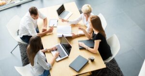 A person tapping on a smartphone screen with another hand holding the device.