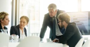 Team Collaboration: Colleagues sharing ideas over a tablet.