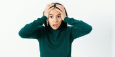 Small business disaster recovery plan template + checklist Stressed business owner holding her head, illustrating the need for a small business disaster recovery plan.