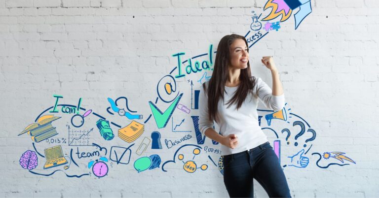 Smiling woman standing in front of a white brick wall decorated with colorful hand-drawn graphics of books, charts, a rocket, and other business symbols, representing ideas, success, and growth.