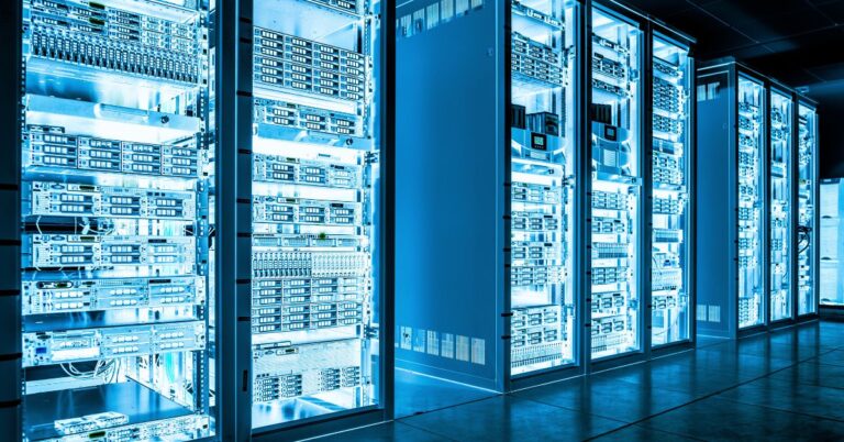 Row of illuminated server racks in a modern data center representing secure data storage.