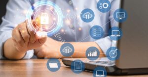 Hand reaching toward a glowing padlock icon above a laptop, with cloud, server, and analytics symbols representing virtual data room security.