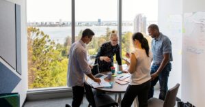 Marketing team meeting in a bright office, representing Adobe’s $1.9 billion Semrush acquisition and the shift toward AI visibility in marketing.