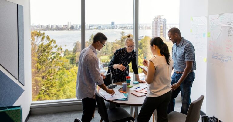 Marketing team meeting in a bright office, representing Adobe’s $1.9 billion Semrush acquisition and the shift toward AI visibility in marketing.