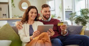 Pinterest graphic showing a smiling couple shopping online with a tablet and credit card, with the headline “How Customers Actually Decide to Buy Today” and TechHelp.ca at the bottom