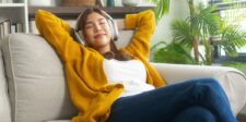 Best 32GB microSD Cards in Canada (2026) Person relaxing on a couch while listening to headphones with a device that may use microSD storage