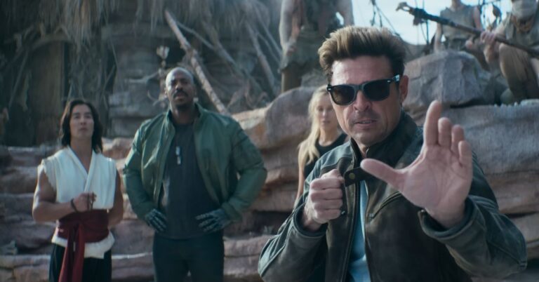 Mortal Kombat II movie scene showing a man in sunglasses holding a knife while other fighters stand behind him.