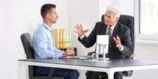 Two business professionals discussing whether ChatGPT ads could fit their marketing strategy.