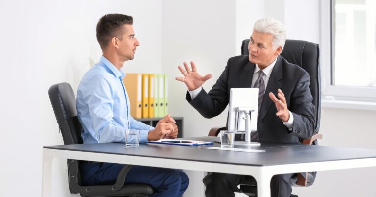 Two business professionals discussing whether ChatGPT ads could fit their marketing strategy.