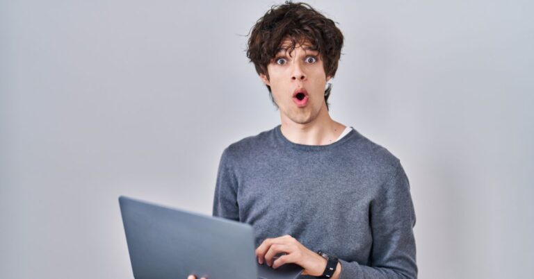 Surprised person holding a laptop, representing the confusion many business owners feel around AI search and SEO changes.