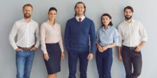 Group of business professionals standing together, representing workplace collaboration and intrapreneurship.